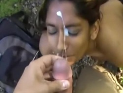 Indian girl giving orall-service outdoors